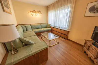 a living room with a couch and a tv at Casa Sette, in centro a Cortina d Ampezzo in Cortina dʼAmpezzo