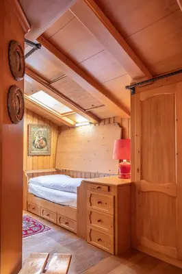 a bedroom with a bed in a wooden cabin at Casa Benedeta, confortevole e panoramica in Cortina dʼAmpezzo