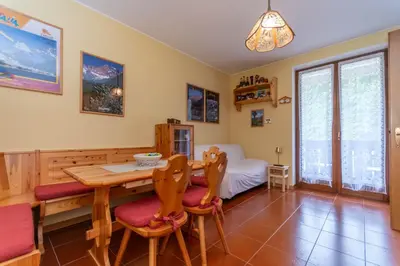 a dining room with a table and chairs at La Finestra sul Civetta in Alleghe