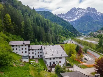 a view of a village with mountains in the background at La Finestra sul Civetta in Alleghe