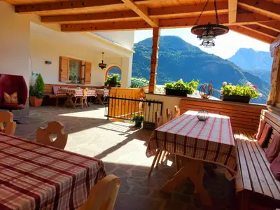 a patio with a table and a view of a mountain at Marxhof in Barbiano