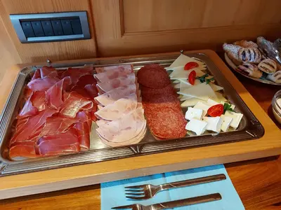 a tray of food with meat and cheese on a table at Marxhof in Barbiano