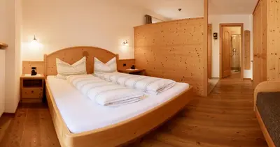 a large bed with white pillows in a room at Marxhof in Barbiano