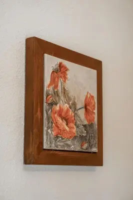 a painting of flowers in a vase on a wall at Öboluckna Appartment in Molini di Tures