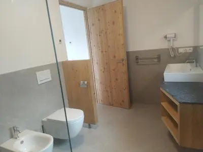 a bathroom with a toilet and a sink at Mitterhofer Appartements in Villandro