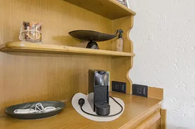 a black phone sitting on top of a wooden shelf at Comfort loft, appartamento centrale con giardino in Cortina dʼAmpezzo