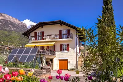 a house with a solar panel in front of it at Micheli Hermann in Caldaro