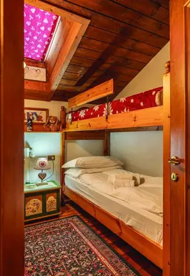 a bedroom with two bunk beds and a window at Casa Mary in San Vito di Cadore