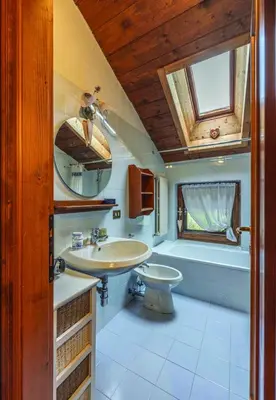 a bathroom with a sink and a toilet and a tub at Casa Mary in San Vito di Cadore