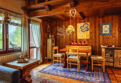 a dining room with a wooden table and chairs at Casa Mary in San Vito di Cadore