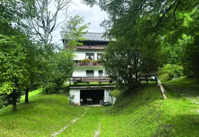 a house with a balcony on top of it at Casa Mary in San Vito di Cadore