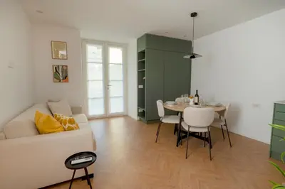 a living room with a white couch and a table at Apartment Merano Mitte in Merano