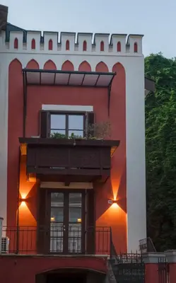 a red and white building with a balcony at Apartment Merano Mitte in Merano