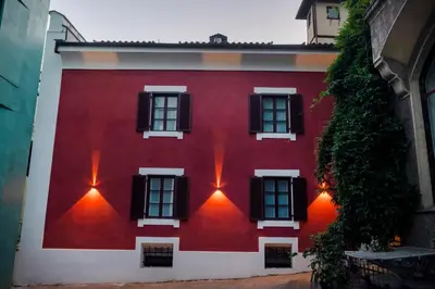 a red and white house with lights on it at Apartment Merano Mitte in Merano