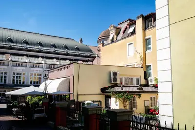 a group of buildings in a city with a fence at Apartment Merano Mitte in Merano