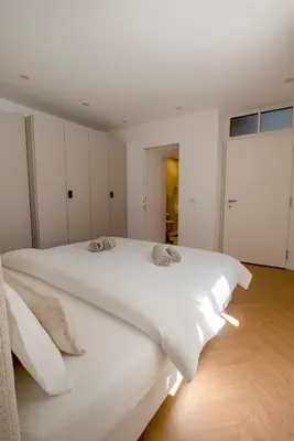 a bedroom with a white bed with two pillows on it at Apartment Merano Mitte in Merano
