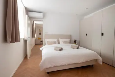 a bedroom with a white bed with two pillows on it at Apartment Merano Mitte in Merano
