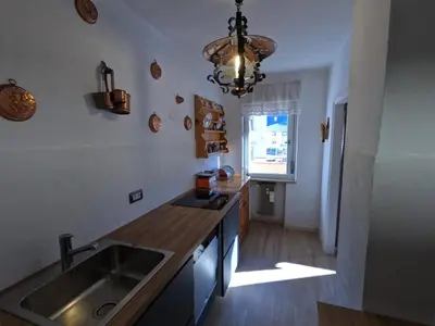 a kitchen with a sink and a counter top at casa Daria in Predazzo