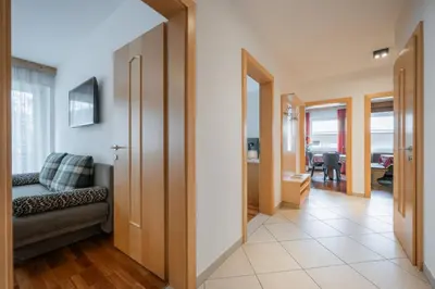 a hallway with a couch and a living room at Haus Petra Mutschlechner in Riscone