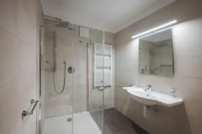 a bathroom with a shower and a sink and a mirror at Haus Petra Mutschlechner in Riscone