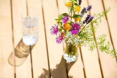 a vase filled with flowers sitting on a table at Ansitz Mair im Korn in Lagundo