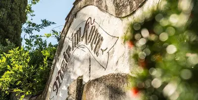 a stone wall with a bird design on it at Ansitz Mair im Korn in Lagundo