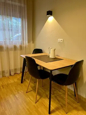 a dining room table with chairs and a lamp at Apartment Martha in Sankt Leonhard in San Leonardo in Passiria