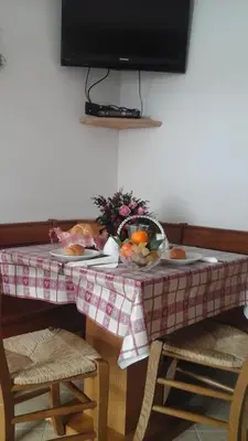 a table with a plate of fruit on it at Cèsa Raggio di Sole in Arabba