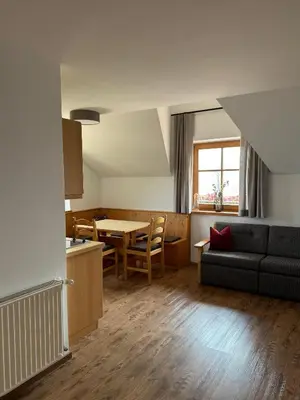 a kitchen and living room with a couch and a table at Törggelehof Lana in Lana