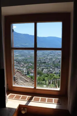 a window in a room with a view of a city at Törggelehof Lana in Lana