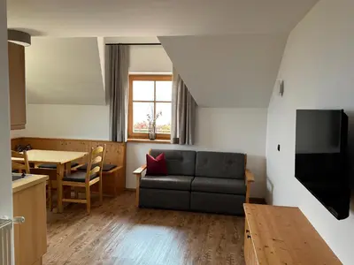 a living room with a couch and a table at Törggelehof Lana in Lana