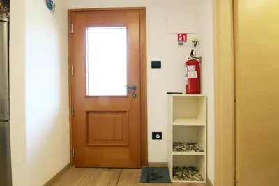 a door in a room with a fire extinguisher at Casa Virginia in Val di Fiemme in Castello di Fiemme