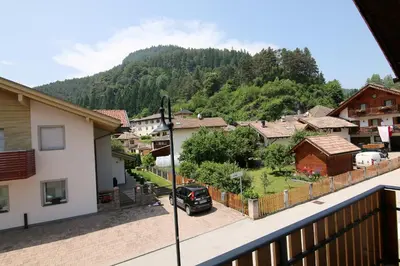 a car parked in a parking lot in a village at Casa Virginia in Val di Fiemme in Castello di Fiemme