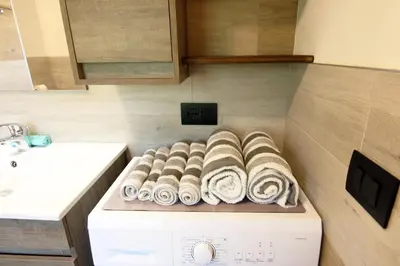 a pile of towels sitting on top of a washing machine at Casa Virginia in Val di Fiemme in Castello di Fiemme