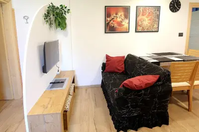 a living room with a couch and a table at Casa Virginia in Val di Fiemme in Castello di Fiemme