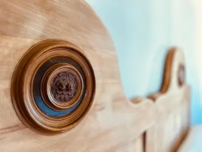 a close up of a wooden clock on a wall at Zum Nussbaum in Termeno