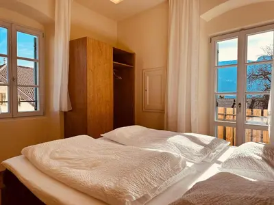 a bedroom with a bed and a window at Zum Nussbaum in Termeno