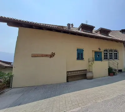 a building with a large pipe on the side of it at Zum Nussbaum in Termeno