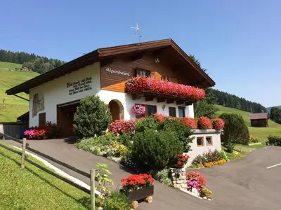 a small church with flowers in front of it at Haus Alpenheim in Braies
