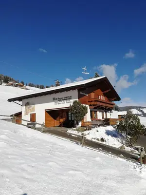 a building with snow in front of it at Haus Alpenheim in Braies