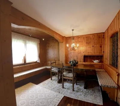 a dining room with a table and a window at Crepedel in Cortina dʼAmpezzo