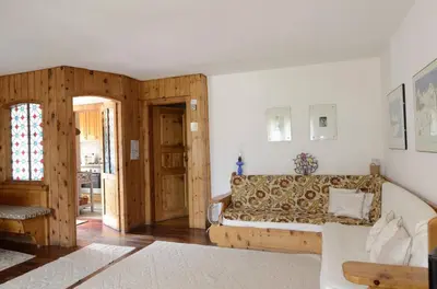 a living room with a couch and a table at Crepedel in Cortina dʼAmpezzo