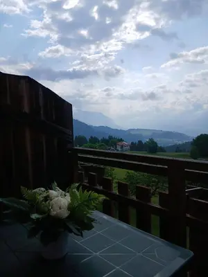 a table with a bouquet of flowers on a balcony at Maso Solandro in Solaiolo