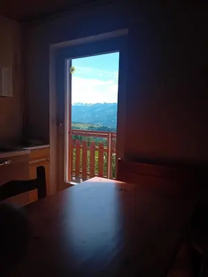 a room with a table and a window with a view at Maso Solandro in Solaiolo