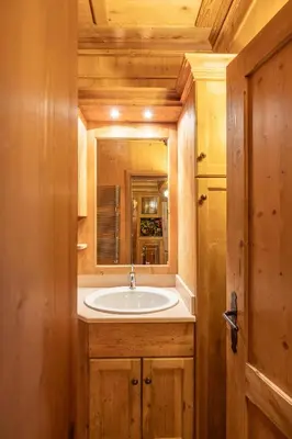 a bathroom with a sink and a mirror at Casa Verocai, graziosi bilocali in centro a Cortina in Cortina dʼAmpezzo