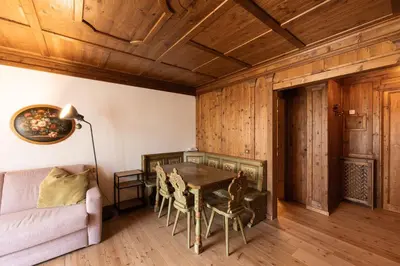 a living room with a table and a couch at Casa Verocai, graziosi bilocali in centro a Cortina in Cortina dʼAmpezzo