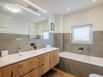 a bathroom with a large tub and a sink at Apartment Erika by Interhome in Canazei