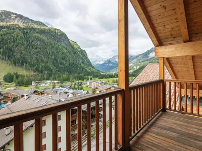 a balcony with a view of a town and mountains at Apartment Erika by Interhome in Canazei