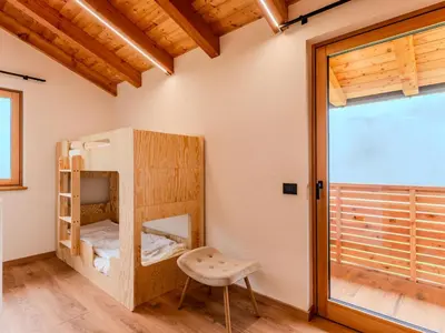 a room with two bunk beds and a window at Villa Casa del Larice by Interhome in Livo