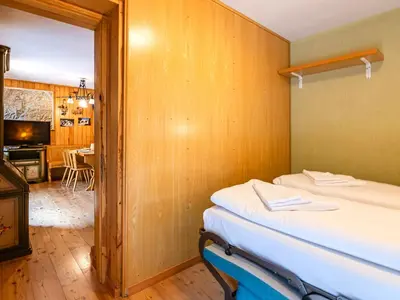 a bedroom with a bed and a living room at Apartment Albert by Interhome in Penia